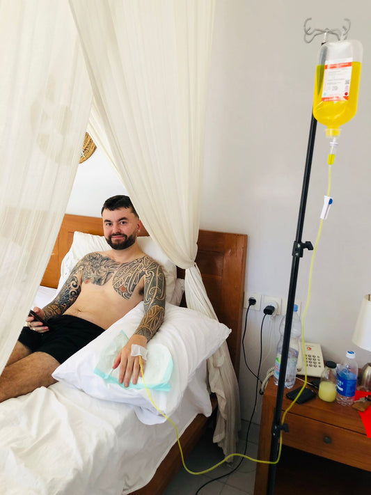 Client receiving IV drip therapy at villa in Bali