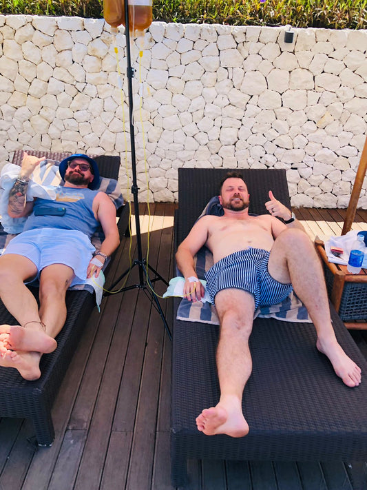 Guests receiving IV drip therapy at a Bali villa pool - Ever Well Health mobile IV service Canggu